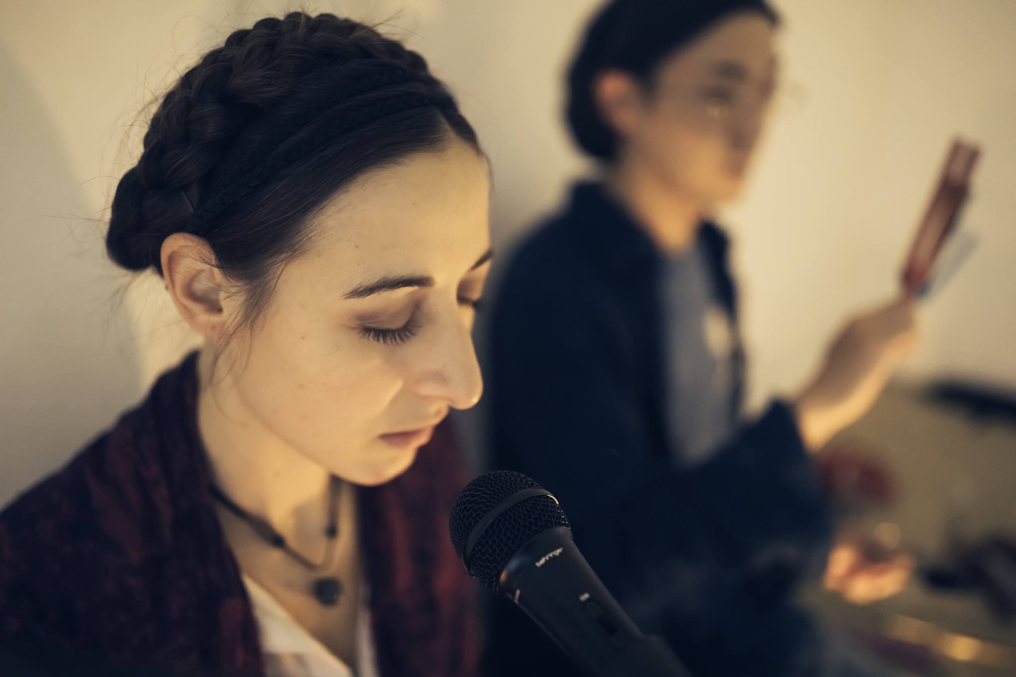 woman with microphone and man with tuning forks